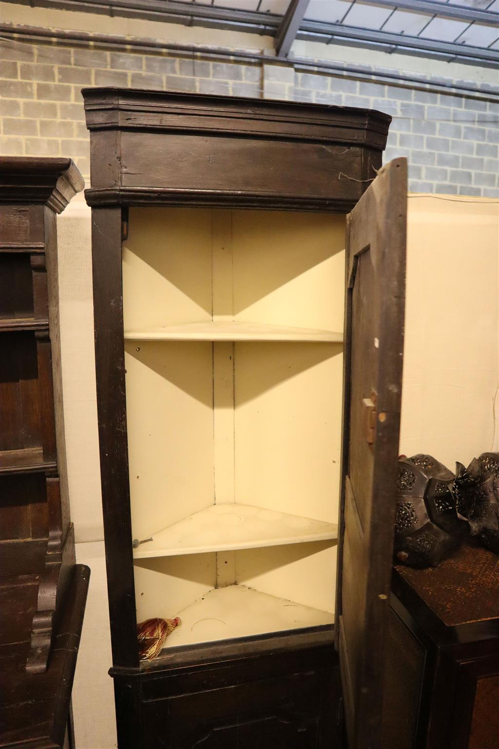 A 17th century style oak corner cupboard, width 58cm, depth 30cm, height 190cm